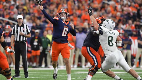 Syracuse quarterback Kyle McCord (6) throws a touchdown pass as offensive lineman Da'Metrius Weatherspoon blocks against Ohio defensive end Ben McNaboe (8) during the first half of an NCAA football game on Saturday, Aug. 31, 2024 in Syracuse, N.Y. (AP Photo/Adrian Kraus)