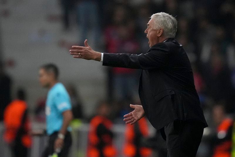 Real Madrid's head coach Carlo Ancelotti protests to referee Maurizio Mariani from Italy during the Champions League opening phase soccer match between Lille and Real Madrid at the Stade Pierre Mauroy in Villeneuve-d'Ascq, outside Lille, France, Wednesday, Oct. 2, 2024. (AP Photo/Thibault Camus)