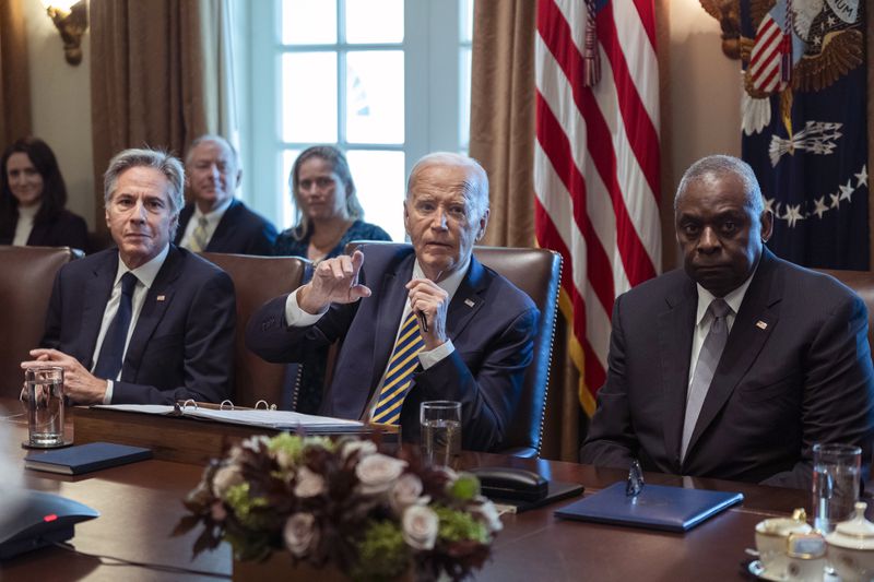 President Joe Biden flanked Secretary of State Antony Blinken, left, and Secretary of Defense Lloyd Austin, right, speaks during a meeting with the members of his cabinet and first lady Jill Biden, in the Cabinet Room of the White House, Friday, Sept. 20, 2024. (AP Photo/Manuel Balce Ceneta)