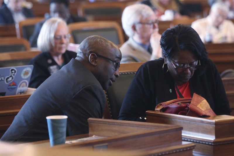 Kansas state Reps. K.C. Ohaebosim, left, D-Wichita, and Valdenia Winn, D-Kansas City, confer during a House debate on a proposal aimed at luring the Kansas City Chiefs and Kansas City Royals from Missouri, Tuesday, June 18, 2024, at the Statehouse in Topeka, Kansas. Ohaebosim and Winn support the proposal, which would authorize state bonds to help finance new stadiums in Kansas. (AP Photo/John Hanna)