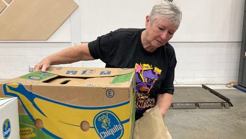 Carolyn Shipman serves at the Atlanta Community Food Bank Feb. 25 with the Dragon Con Superheroes, a community outreach program she's been involved with since 2014. Courtesy of Greg Euston