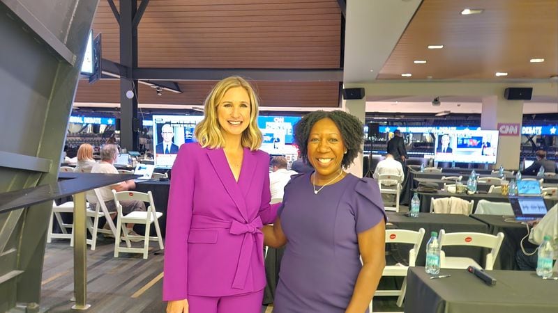 AJC's Washington correspondent Tia Mitchell and CBS News’ Caitlin Huey-Burns wore purple to Thursday's presidential debate. They were two of many who did not choose Team Red or Team Blue.