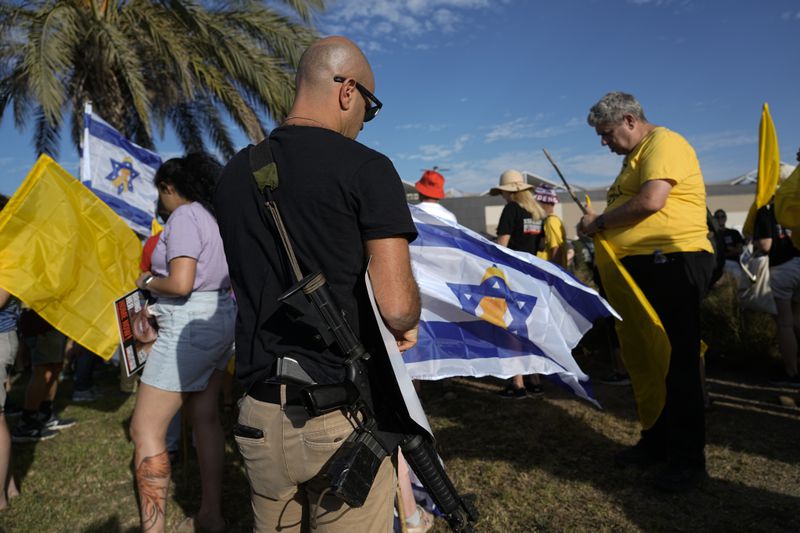 Relatives and friends of hostages held in the Gaza Strip by the Hamas militant group attend a protest in a convoy of vehicles to the Gaza border, in Ashkelon, Wednesday, Aug. 28, 2024. (AP Photo/Tsafrir Abayov)