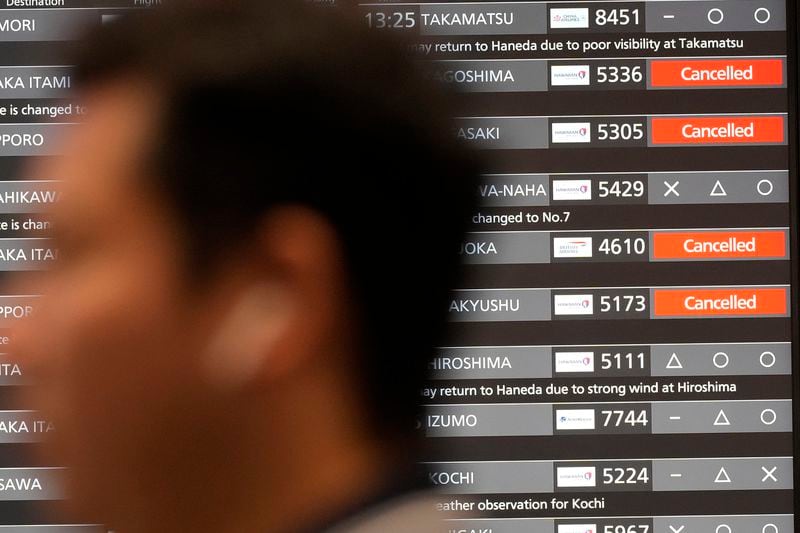 A departing flight information board shows that some flights were canceled due to an approaching Typhoon Shanshan at Haneda airport Thursday, Aug. 29, 2024, in Tokyo. (AP Photo/Eugene Hoshiko)