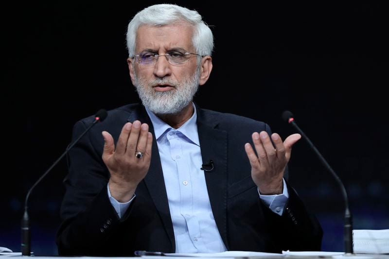 In this picture made available by Iranian state-run TV, IRIB, candidate for the presidential election Saeed Jalili, a hard-line former Iranian top nuclear negotiator, speaks in a debate with the reformist candidate Masoud Pezeshkian at the TV studio in Tehran, Iran, Monday, June 1, 2024. (Morteza Fakhri Nezhad/IRIB via AP)