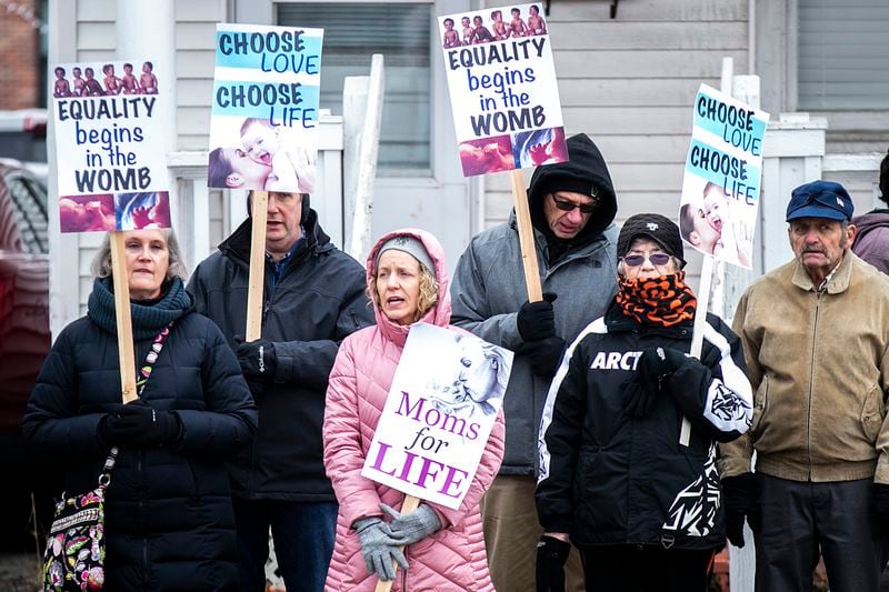 FILE - Anti-abortion activists hold signs during a March for Life rally, Jan. 21, 2023, across from the Emma Goldman Clinic in Iowa City, Iowa. The Iowa Supreme Court reversed a lower court ruling that put a temporary block on the state’s strict abortion law, Friday, June 28, 2024, and is telling the lower court to let the law take effect. The new law bans most abortions after about six weeks of pregnancy and before many women know they are pregnant. (Joseph Cress /Iowa City Press-Citizen via AP, File)