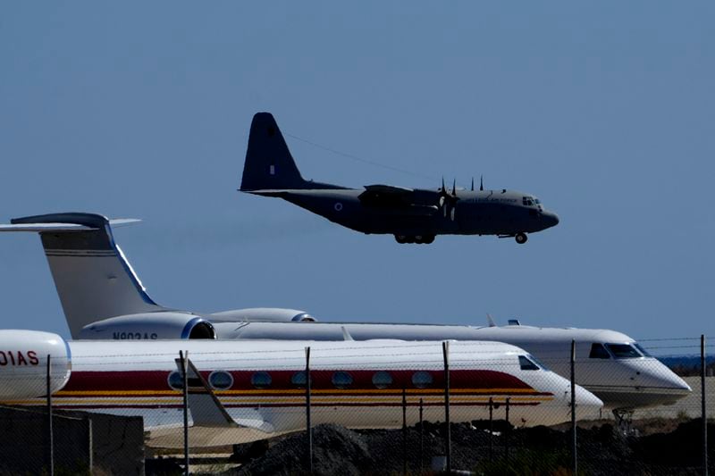 A Greek military transport aircraft carrying Greek and Cypriots citizens evacuated from Lebanon prepares for landing at Larnaca airport, Cyprus, on Thursday, Oct. 3, 2024. (AP Photo/Petros Karadjias)