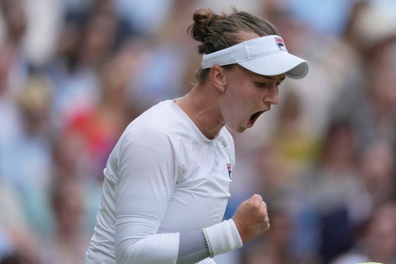 Barbora Krejcikova of the Czech Republic reacts after winning a game as she plays against Jasmine Paolini of Italy during the women's singles final at the Wimbledon tennis championships in London, Saturday, July 13, 2024. (AP Photo/Mosa'ab Elshamy)