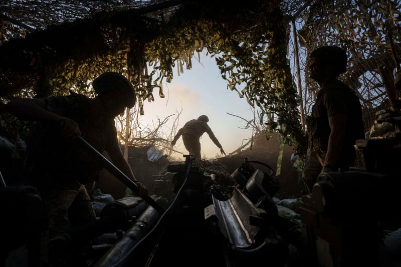 Ukrainian servicemen of 148th separate artillery brigade of the Air Assault Forces prepare M777 howitzer to fire towards Russian positions at the frontline in Donetsk region, Ukraine, Wednesday, August 21, 2024. (AP Photo/Evgeniy Maloletka)