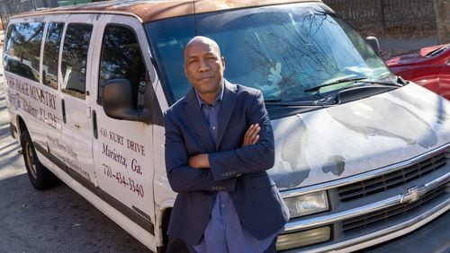 The Rev. Siegfried Darcell White, with Not on My Watch Ministry, poses for a portrait in front of his van in Atlanta on Thursday, Jan. 18, 2024, after driving unhoused people to a warming center. (Arvin Temkar / arvin.temkar@ajc.com)