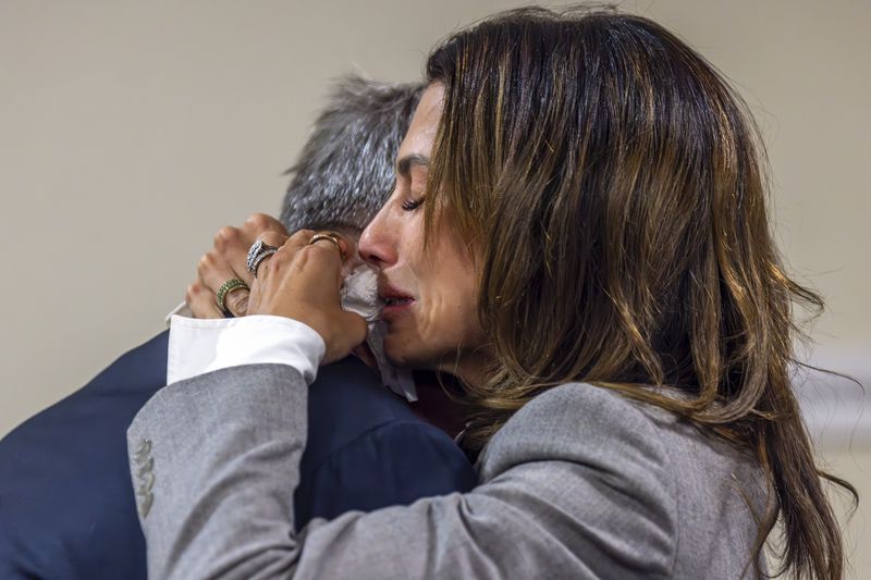 Actor Alec Baldwin hugs wife Hilaria Baldwin after District Court Judge Mary Marlowe Sommer threw out the involuntary manslaughter case against Baldwin for the 2021 fatal shooting of cinematographer Halyna Hutchins during filming of the Western movie "Rust," Friday, July 12, 2024, in Santa Fe, N.M. (Luis Sánchez Saturno/Santa Fe New Mexican via AP, Pool)