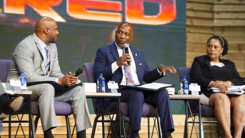 Gwinnett County Superintendent Calvin Watts speaks during a panel about school safety and community violence Wednesday, Nov. 2, 2022, at New Mercies Christian Church in Lilburn. Among the panelists were New Mercies Pastor Jesse Curney III (left) and District Attorney Patsy Austin-Gatson (right). Gwinnett County Public Schools has seen a streak of violence and safety issues, leading district and community leaders to meet to discuss potential solutions. (Christina Matacotta for The Atlanta Journal-Constitution)