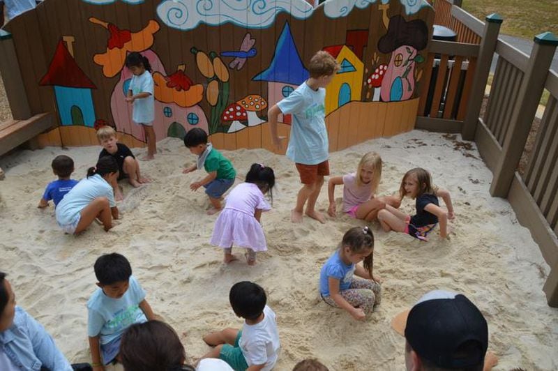 Kids play in a sandbox at the new PlayTown Suwanee playground. (Photo Courtesy of Curt Yeomans)
