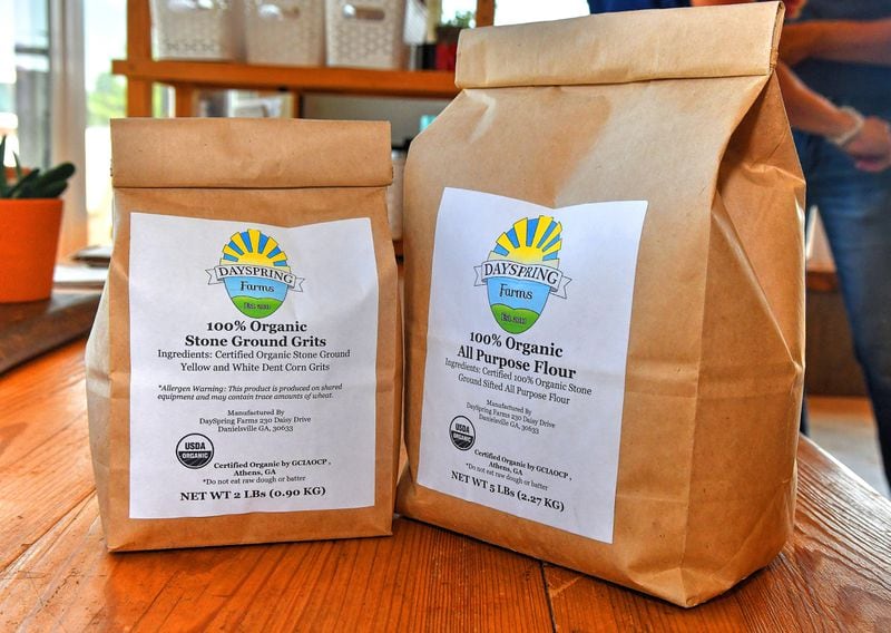 Two products from DaySpring Farms are Stone Ground Grits (2 pounds) and All Purpose Flour (5 pounds). The smaller bags are intended for the home cooks, while there are 50-pound bags used more by large bakeries and restaurants. DaySpring Farms is an organic certified farm that grows, harvest and mills grains on-site. (Chris Hunt for The Atlanta Journal-Constitution)