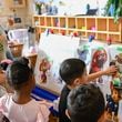 Preschool teacher Tinhinane Meziane, left, listens to her students on what characters of the TV show PAW Patrol they will vote for as their favorite character at the ACCA Child Development Center, Thursday, Sept. 19, 2024, in Annandale, Va. The students are getting foundational lessons on how to live in a democracy by allowing them to regularly vote on different things through out the day. (AP Photo/John McDonnell)