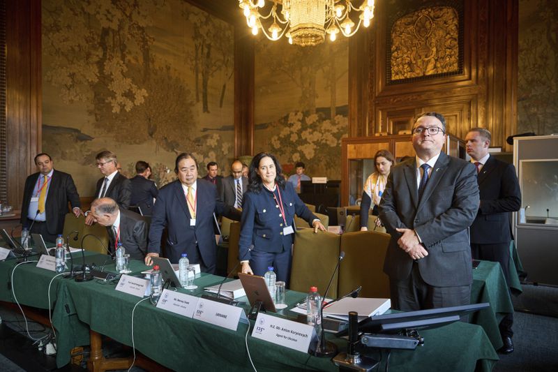 The Ukrainian delegation at the start of PCA Case between Ukraine and the Russian Federation in the Netherlands, Monday, Sept. 23, 2024. (AP Photo/Phil Nijhuis)