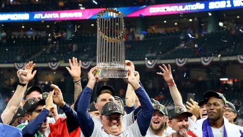 11/2/21 - Houston, Tx. - Atlanta Braves manager Brian Snitker hoists the Commissioner's Trophy after defeating the Houston Astros 7-0 in game six of the World Series at Minute Maid Park, Tuesday, November 2, 2021, in Houston, Tx. The Atlanta Braves beats the Houston Astros 4-2 to take the World Series. Curtis Compton / curtis.compton@ajc.com