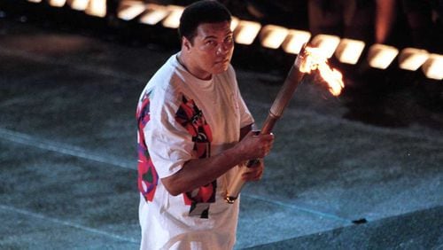 Muhammad Ali lights the torch to launch the 1996 Olympics in Atlanta. (AJC file photo)