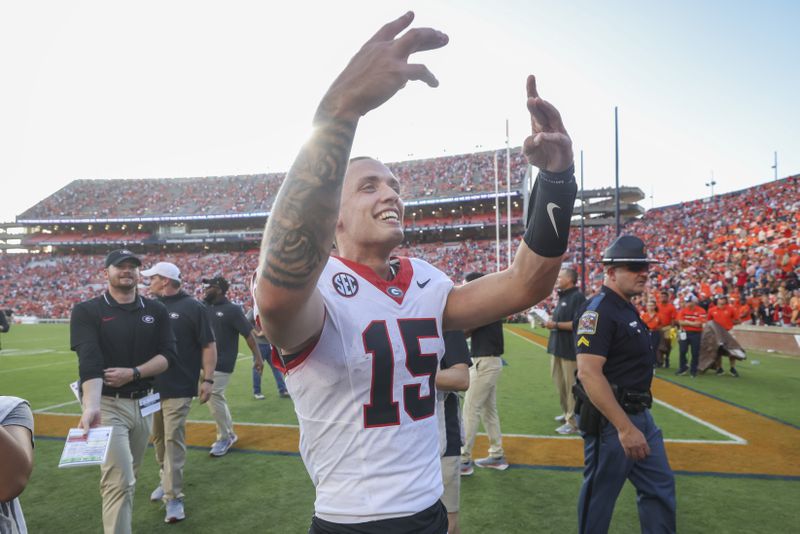 Georgia quarterback Carson Beck (15) celebrates their win against Auburn at Jordan-Hare Stadium, Saturday, September 30, 2023, in Auburn, Al. Georgia won 27-20. Georgia won 27-20. Beck had 318 yards passing and the go-ahead touchdown. (Jason Getz / Jason.Getz@ajc.com)