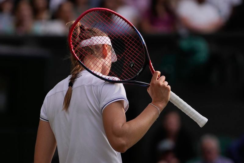 Elena Rybakina of Kazakhstan plays a reacts during her semifinal match against Barbora Krejcikova of the Czech Republic at the Wimbledon tennis championships in London, Thursday, July 11, 2024. (AP Photo/Alberto Pezzali)