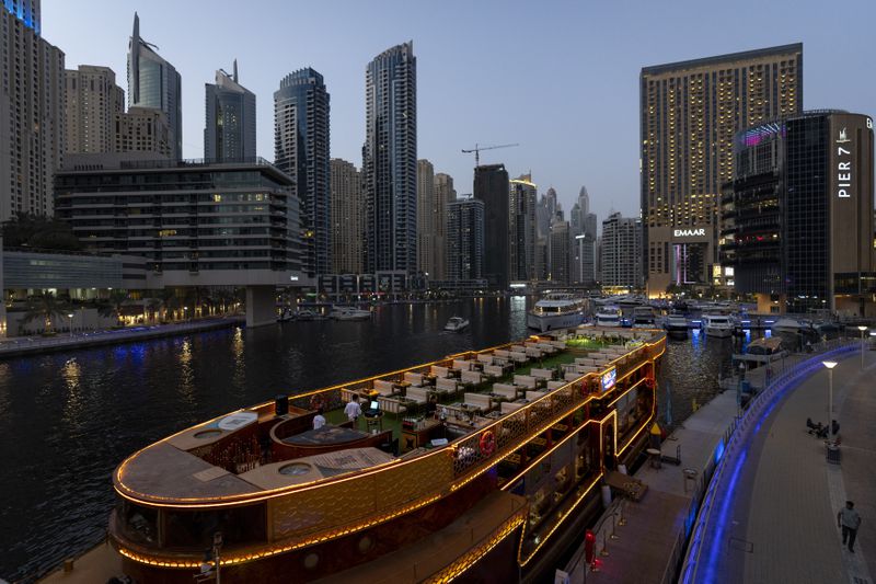 A floating restaurant is seen decked up as it is is anchored at Dubai Marina Walk in Dubai, United Arab Emirates, Tuesday, Aug. 13, 2024. (AP Photo/Altaf Qadri)