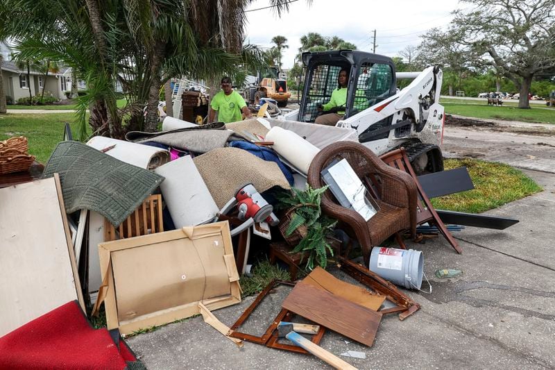 Contractors with the City of New Port Richey help clean debris left by Hurricane Helene in preparation for Hurricane Milton on Monday, Oct. 7, 2024, in New Port Richey, Fla. (AP Photo/Mike Carlson)