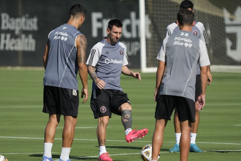 Inter Miami forwards Lionel Messi, center, and Luis Suarez, left, work out with defender Noah Allen, right, at the MLS soccer team's training facility, Friday, Sept. 13, 2024, in Fort Lauderdale, Fla. (AP Photo/Wilfredo Lee)