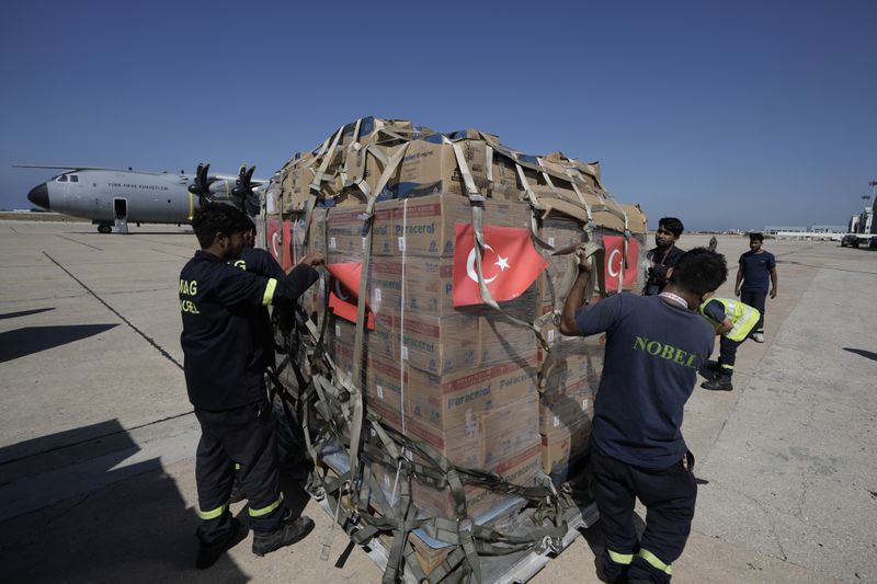 Workers unload Turkish medical aid boxes arriving at Beirut International airport, Wednesday, Sept. 25, 2024. (AP Photo/Bilal Hussein)