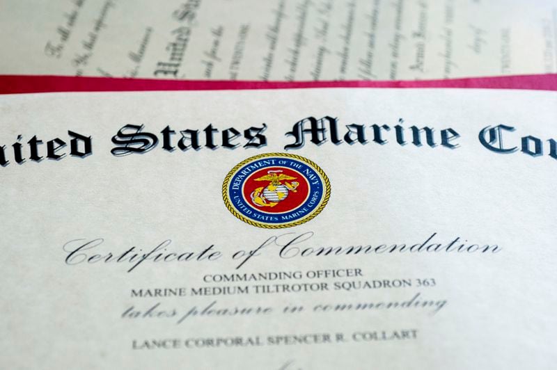 A Certificate of Commendation for Marine Corporal Spencer R. Collart is seen at the home of his parents in Arlington, Va., Thursday, June 19, 2024. Collart, 21, was killed along with two other Marines when the MV-22B Osprey aircraft they were on crashed during drills on a north Australian island on August 27, 2023. (AP Photo/Rod Lamkey, Jr.)