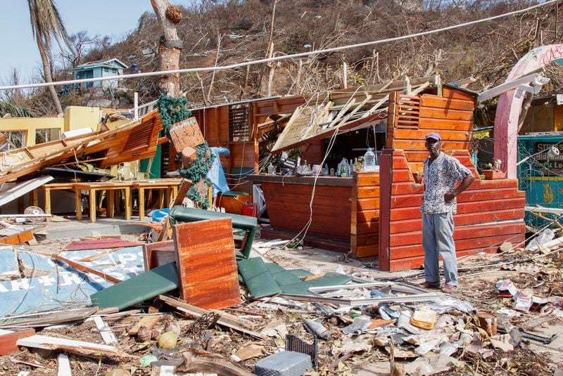 A man stands next to a business destroyed by Hurricane Beryl in Clifton, Union Island, St. Vincent and the Grenadines, Thursday, July 4, 2024. (AP Photo/Lucanus Ollivierre)