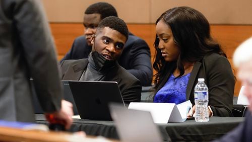 Kahlieff Adams speaks with his attorney Teombre Calland during jury selection in the Young Slime Life gang trial.  (Natrice Miller/natrice.miller@ajc.com)