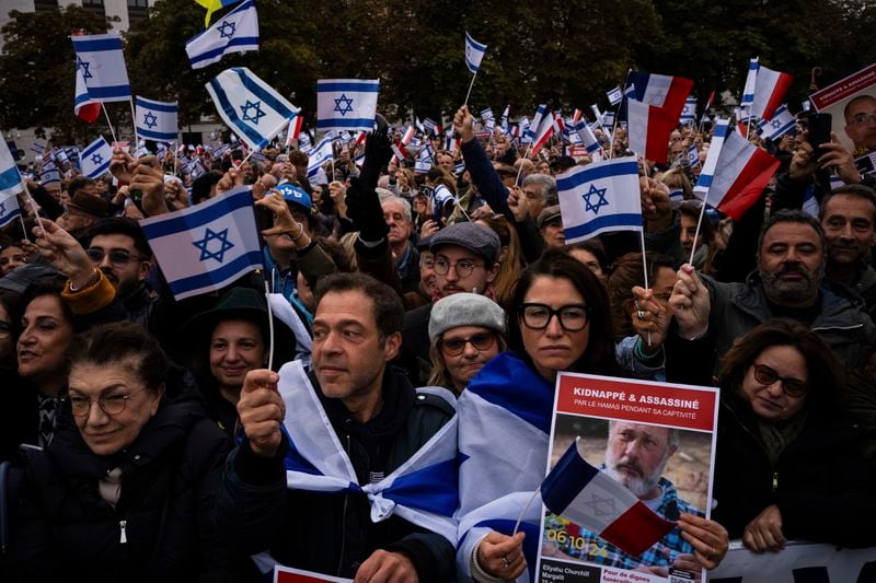 People attend a demonstration in support of Israel to mark the first anniversary of the Hamas attack on Israel, in Paris, Sunday, Oct. 6, 2024. (AP Photo/Louise Delmotte)