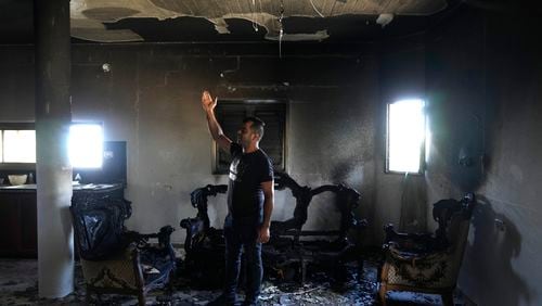 A Palestinian stands in his home the morning after it was torched in a rampage by Israeli settlers in the West Bank village of Jit, Friday, Aug. 16, 2024. (AP Photo/Nasser Nasser)