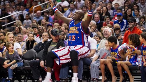 Harlem Globetrotter big man Big Easy Lofton, all 6-foot-9 and 250 pounds of him, playfully takes a courtside seat, ignoring the fan already sitting there. The Globetrotters cancelled games as the global pandemic surged. CONTRIBUTED BY HARLEM GLOBETROTTERS