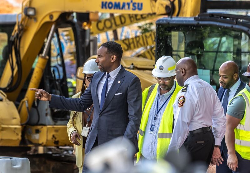 Atlanta Mayor Andre Dickens said Monday he takes the public's criticism to heart.  Crews continue to work on a broken water main on West Peachtree Street in Midtown, with nearby residents warned of impacts to their water service as the crisis reaches its fourth stage.  Monday, June 3, 2024. Water was gushing from the broken water main until Monday morning, when workers were seen pumping water.  (John Spink/AJC)