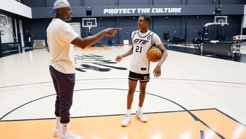 Damien Wilkins, (right) general manager and head of basketball operations at Overtime Elite Arena, interacts with his son Jayden Wilkins after he finishes practice on Monday, Nov. 6, 2023. (Miguel Martinez /miguel.martinezjimenez@ajc.com)