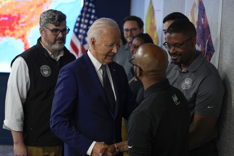 President Joe Biden greets people during a visit to the D.C. Emergency Operations Center, Tuesday, July 2, 2024, in Washington. (AP Photo/Evan Vucci)