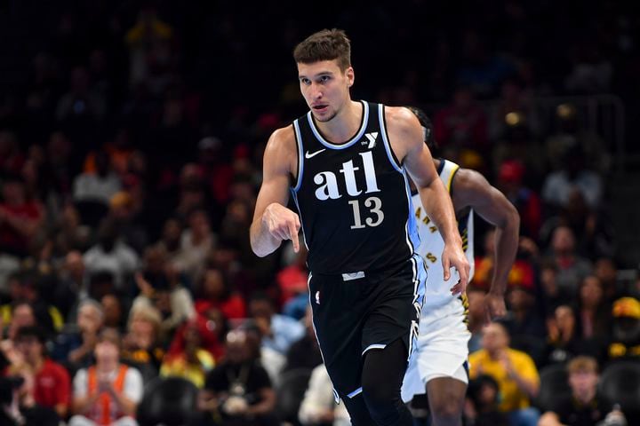 Atlanta Hawks guard Bogdan Bogdanovic (13) gestures after scoring a 3-pointer against the Indiana Pacers during the first half of an NBA game Tuesday, November 21, 2023. (Daniel Varnado/For the AJC)