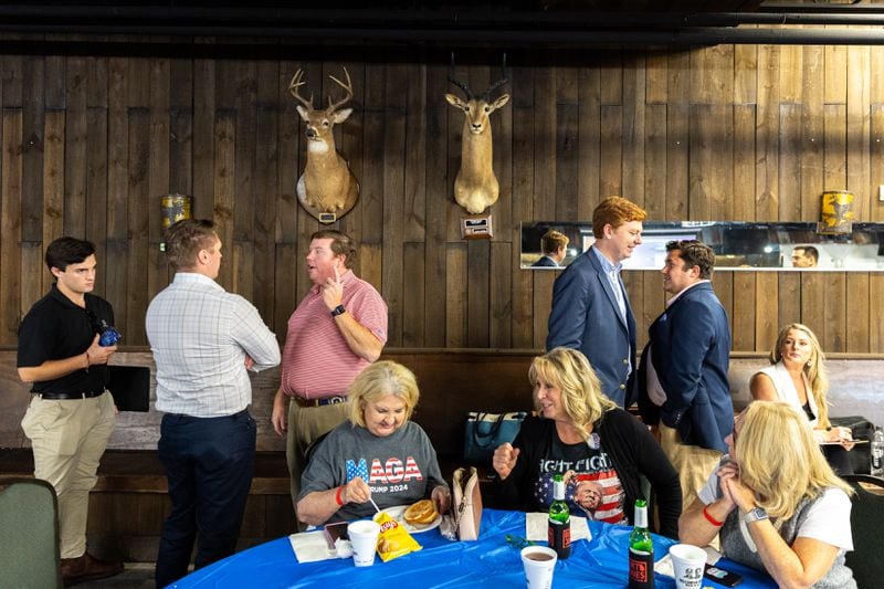 Republican attendees socialize during a presidential debate watch party at gun store and indoor shooting range Adventure Outdoor in Smyrna on Tuesday, September 10, 2024. Candidates Vice President Kamala Harris and President Donald Trump are debating in Philadelphia. (Arvin Temkar / AJC)