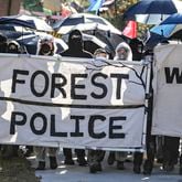 November 13, 2023 Atlanta: Protesters head through the neighborhoods to the showdown with police on Constitution Road. After a weekend of protest training, opponents of AtlantaÕs public safety training center began marching Monday morning from Gresham Park Recreation Center to the site where the $90 million facility is under construction in what organizers are calling a non-violent ÒDay of Action.Ó A few hundred people participated in the march, most wearing masks and many donned in plastic painters suits. City officials say the new center is necessary to provide world-class training to its officers and firefighters, which are currently using outdated facilities. Opponents say it will be used to further militarize police and construction will destroy swaths of one of the largest urban forests in the country. (John Spink / John.Spink@ajc.com)

