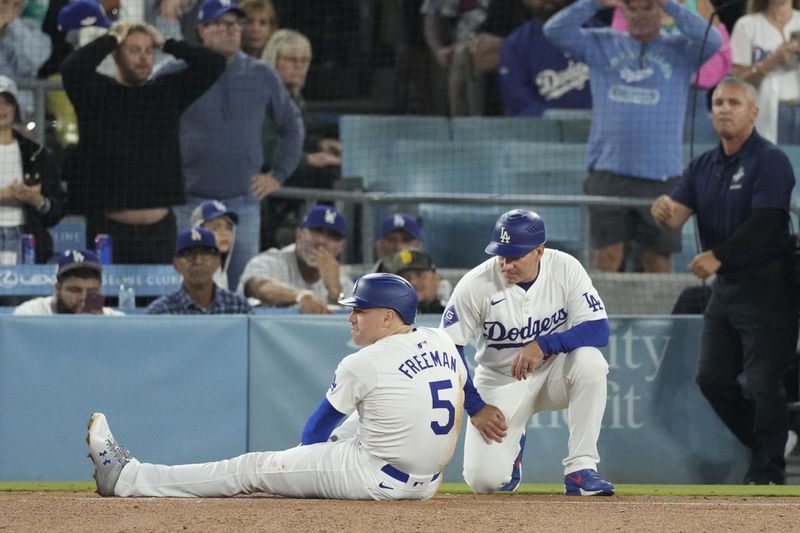 Los Angeles Dodgers' Freddie Freeman (5) suffers an injury after grounding out during the seventh inning of a baseball game against the San Diego Padres, Thursday, Sept. 26, 2024, in Los Angeles. (AP Photo/Mark J. Terrill)