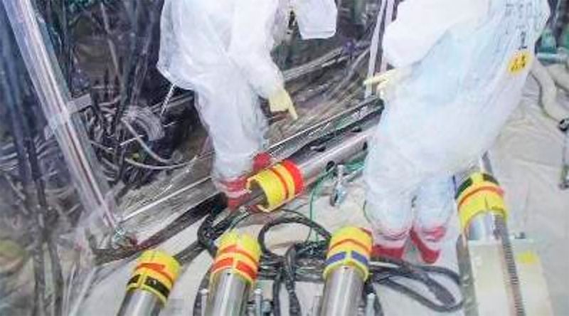 In this photo released by Tokyo Electric Power Company Holdings (TEPCO), monitoring workers rearrange the push-in pipes into the right order, at Fukjushima Daiichi nuclear power plant in Okuma, Fukushima prefecture, northern Japan Saturday, Sept. 7, 2024. (Tokyo Electric Power Company Holdings via AP)