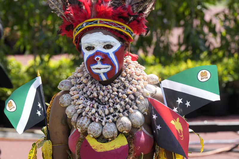 A woman in traditional dress attends an address by Pope Francis during meeting with young people in the Sir John Guise Stadium in Port Moresby, Papua New Guinea, Monday, Sept. 9, 2024. (AP Photo/Mark Baker)