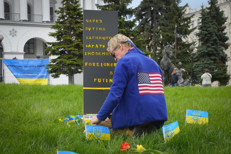 Ryan Wesley Routh pays tribute to foreign citizens killed during Russia-Ukraine war in a central square in Kyiv, Ukraine, Saturday, April 30, 2022. (AP Photo/Efrem Lukatsky)