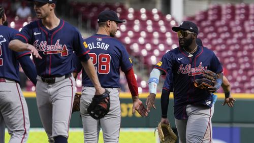 Atlanta Braves' Michael Harris II, right, celebrates with Matt Olson, center, after a victory in a baseball game against the Cincinnati Reds, Thursday, Sept. 19, 2024, in Cincinnati. (AP Photo/Joshua A. Bickel)