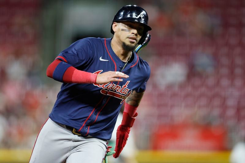 Atlanta Braves' Orlando Arcia scores from second base on a hit by teammate Gio Urshela against the Cincinnati Reds during the ninth inning of a baseball game, Wednesday, Sept. 18, 2024, in Cincinnati. (AP Photo/Jay LaPrete)