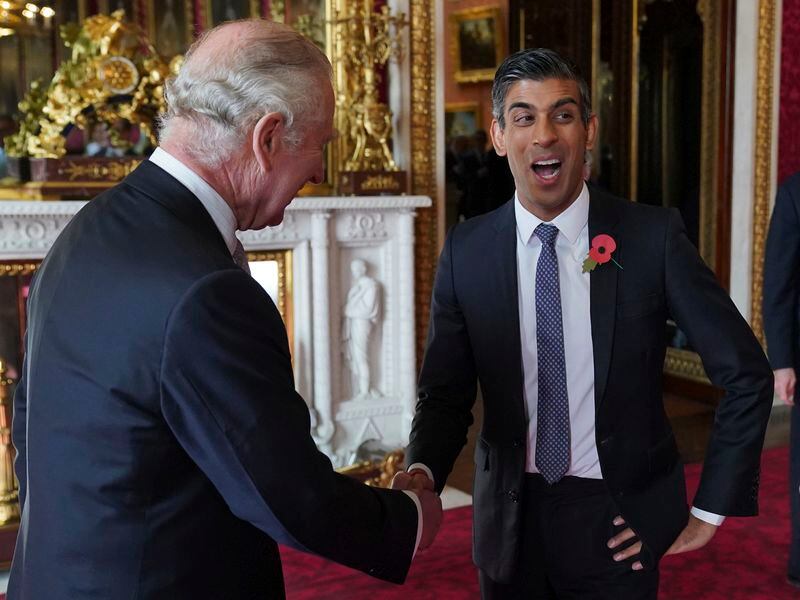 FILE - Britain's King Charles III speaks with Prime Minister Rishi Sunak during a reception at Buckingham Palace, London, on Nov. 4, 2022, ahead of the COP27 Summit. Shortly after Sunak called early parliamentary elections for July 4, Buckingham Palace said that all members of the royal family were cancelling most public engagements until after the vote to avoid doing anything that might divert attention from the campaign. (Jonathan Brady/Pool Photo via AP, File)