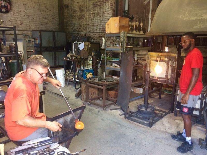 Matt Janke (left), who for 20 years has run a glass shop near what is now the Beltline, said, “It’s beyond me why they’re getting a tax break.” Arthur Wilson is on the right. BILL TORPY / BTORPY@AJC.COM