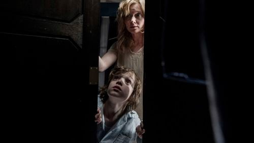 This image released by IFC Films shows Noah Wiseman, bottom, and Essie Davis in a scene from the film "The Babadook." (IFC Films via AP)