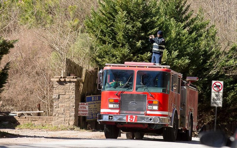 A member of the South Fulton Fire Department takes photos of an unlicensed landfill, located at 7635 Bishop Road, in South Fulton, Wednesday, Feb. 13, 2019. (ALYSSA POINTER/ALYSSA.POINTER@AJC.COM)